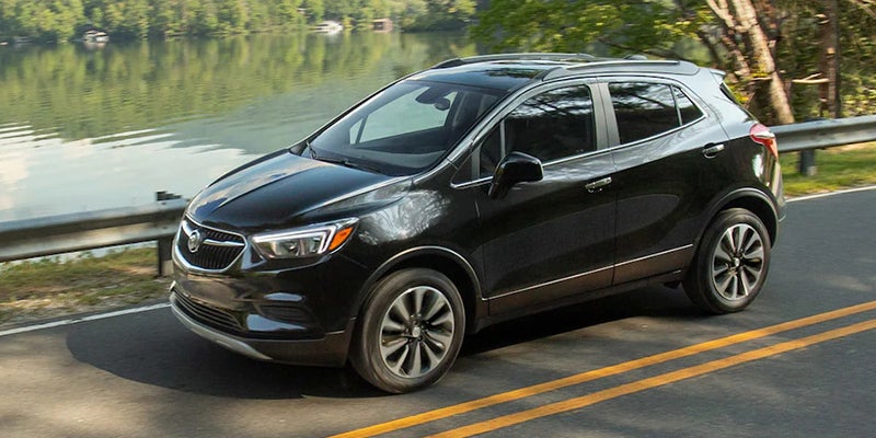 Black 2022 Buick Encore exterior on road by lake